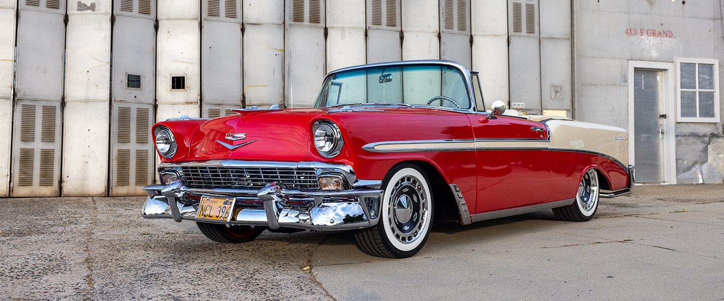 A front three quarter view of Jon Henson's red Chevy Bel Air in an empty lot